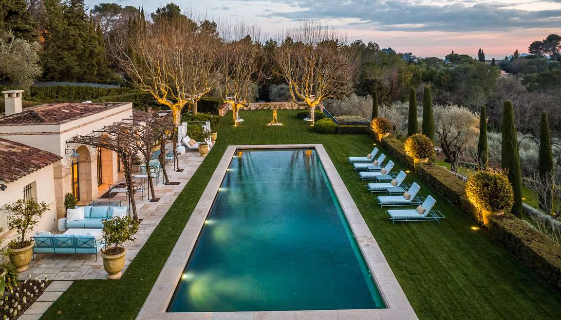 Pool house avec pergola en glycine et coin lounge au coucher du soleil