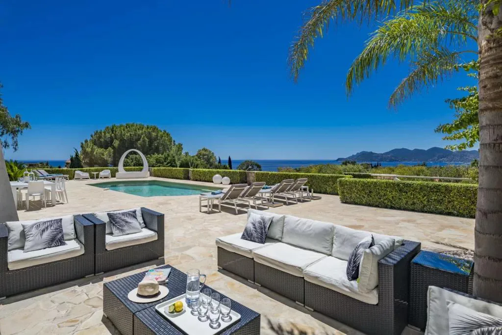 Terrasse plein jour avec bains de soleil et piscine