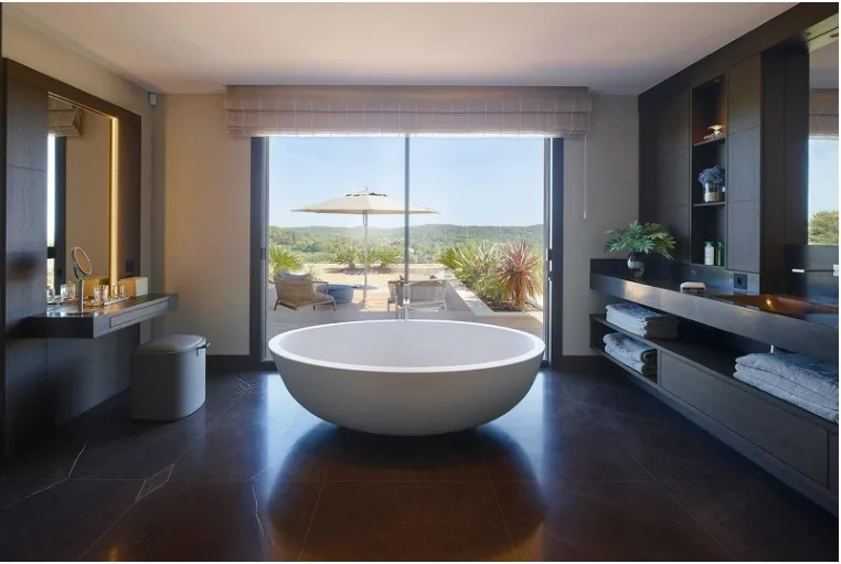 Salle de bain avec baignoire ovale freestanding vue jardin